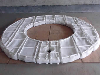 A ring shape PP mist eliminator with top grid is on the cardboard.