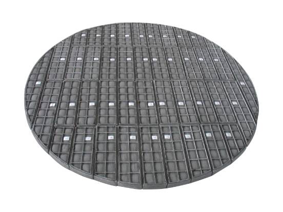 A piece of stainless steel demister pad on the ground.