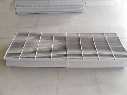 A rectangular shape plastic vane demister pad on the ground.